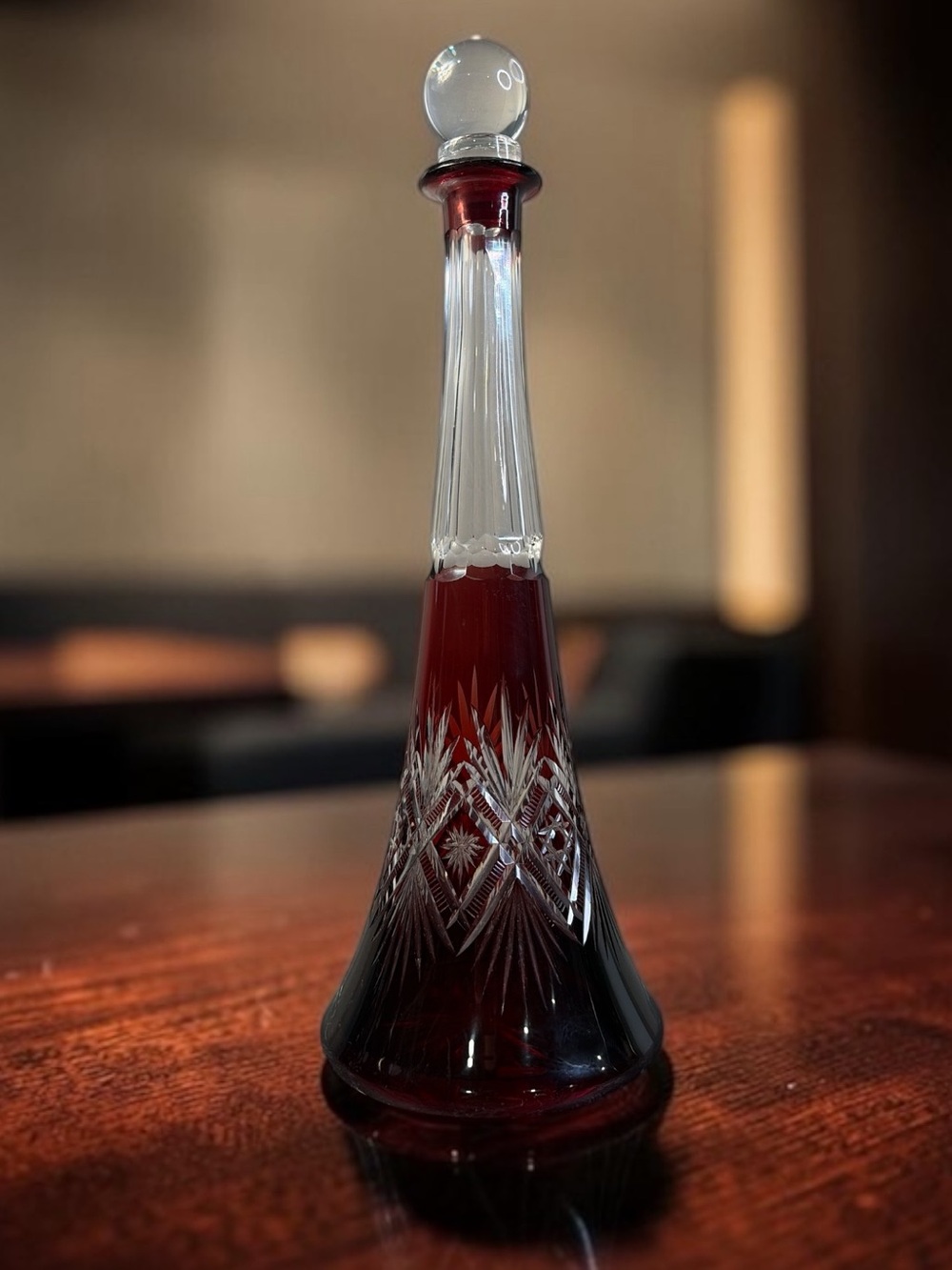 BOHEMIAN-STYLE RUBY RED CUT GLASS DECANTER WITH CLEAR BALL STOPPER 16”